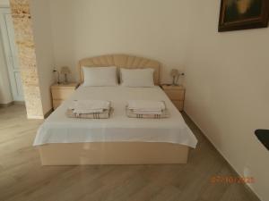a bedroom with a large bed with two night stands at "Vera old City" in Tbilisi City