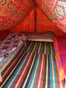 a room with two beds in a tent at L'Oasis in Ksar Ghilane