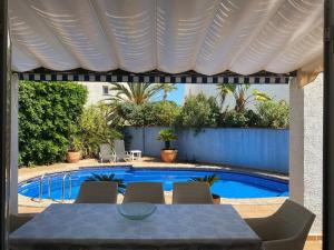 a patio with a table and a swimming pool at Mojacar Villa - Villa Caletta - 4 bedroom - sleeps 8 - R954 in Mojácar