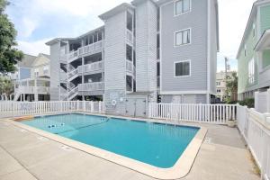 a swimming pool in front of a apartment building at 2nd Row Beach Condo, steps to the beach, with Pool in Myrtle Beach