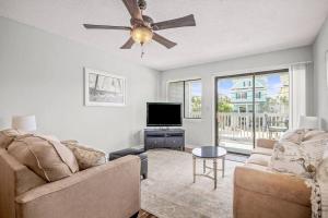 a living room with a couch and a ceiling fan at 2nd Row Beach Condo, steps to the beach, with Pool in Myrtle Beach