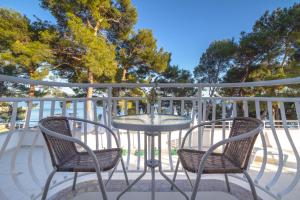 a table and two chairs on a balcony at Hotel Bor in Krk