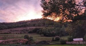 a view of a hill with the sun setting at La Petite Porte Verte in Bouilland