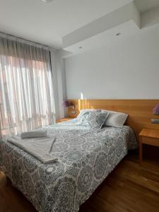 a bedroom with a bed and a large window at Samaniego suite, AirPort, ifema turístico in Madrid