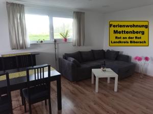a living room with a couch and a table at Ferienwohnung Mettenberg in Rot an der Rot