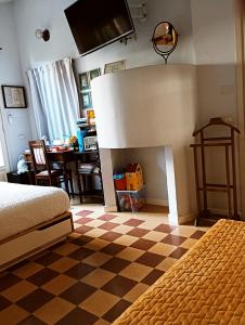 a bedroom with a bed and a checkered floor at B&B Casa Lulù in Brembate