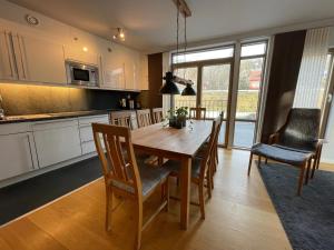 奧勒的住宿－Åre Travel - Mörviksgården，厨房以及带木桌和椅子的用餐室。