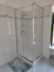 a shower with a glass enclosure in a bathroom at Villa Melina lafattoriasecondonoi in Casa Criscione