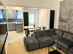a living room with a couch and a table at Modern City Centre Townhouse sleeps 10 & Parking in Manchester