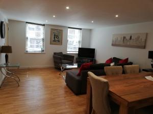 a living room with a couch and a table at Crown House is a brand new development with unique features in Newbury