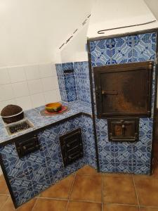 a kitchen with blue tiled walls and an oven at Villa Melina lafattoriasecondonoi in Casa Criscione