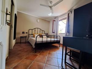 a bedroom with a bed and a large window at B&B Tenuta Campo Magliano in Bigliolo