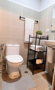 a bathroom with a toilet and a sink at SMDC Coast Residences in Manila