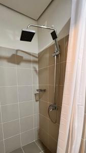 a shower with a shower head in a bathroom at CozyCoastStay by APPLETRAVELBEYONDPH in Manila +16 photos