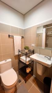 a bathroom with a toilet and a sink at CozyCoastStay by APPLETRAVELBEYONDPH in Manila