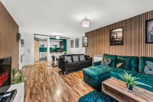 a living room with a couch and a table at Spacious Central Manchester Apartment - Sleeps 8 in Manchester