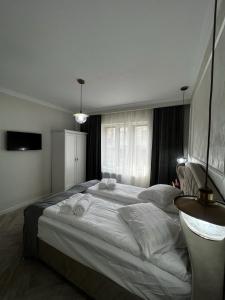 a bedroom with a large bed with towels on it at Casa moderna situata in zona centrala a orasului in Tulcea