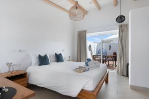 a bedroom with a large white bed with a view of the ocean at Quinta do Ourives in Carvoeiro