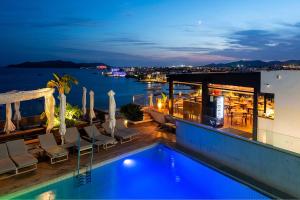 a pool on the roof of a building at night at Hotel Cenit & Apts Sol y Viento in Ibiza Town