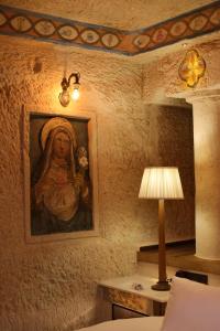 a room with a painting of a woman on the wall at Utopia Cave Cappadocia in Urgup