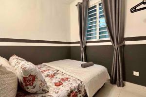 a bedroom with a bed and a window at 'A'ffordable Spacious 6pax S PICE Penang in Bayan Lepas