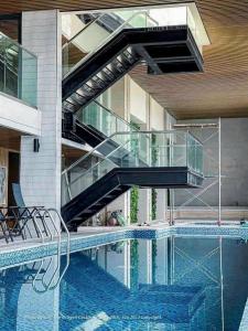 a swimming pool with a staircase in a building at Yên House in Ha Long