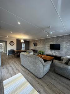 a living room with two couches and a table at Goulden Street Guest House in East London