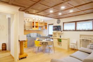 a kitchen and living room with a table and chairs at Stella Alpina House in Courmayeur
