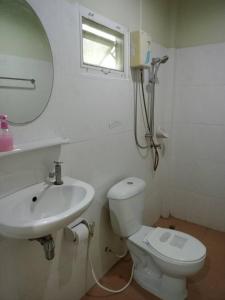 a bathroom with a sink and a toilet and a mirror at Waterjade Resort in Phangnga