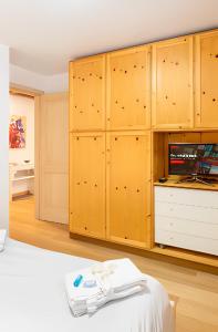 Una habitación con armarios de madera y una cama. en Stella Alpina House, en Courmayeur