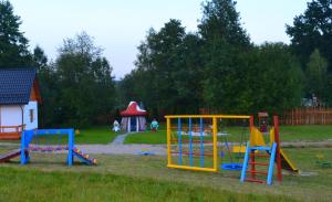 einen Spielplatz mit bunter Spielausrüstung in einem Park in der Unterkunft Niesamowita Dolina 