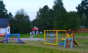 a playground with colorful play equipment in a park at Niesamowita Dolina in Zdonia