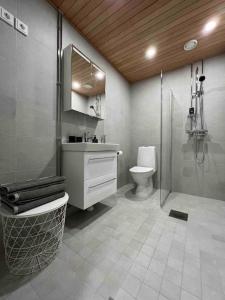 a bathroom with a shower and a sink and a toilet at Brand new modern condo built-in Mall of Tripla in Helsinki