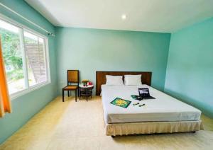 a bedroom with a bed with a blue wall at Waterjade Resort in Phangnga