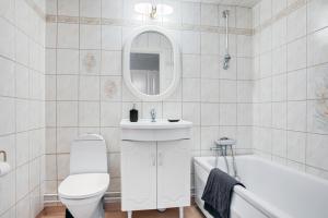 a bathroom with a toilet and a sink and a tub at Nice home, where you can feel home at vikingavägen 75 in Gävle