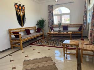 a living room with two couches and a window at Beit Tolba in Dahab