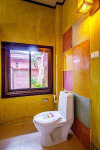 a bathroom with a toilet and a window at Waterjade Resort in Phangnga