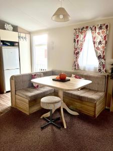 a living room with a couch and a table at 6 Birth Caravan Ingoldmels in Ingoldmells