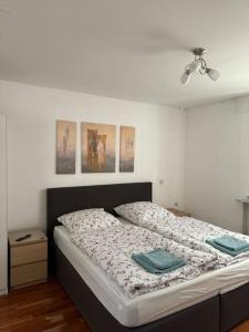 a bedroom with a large bed with two pillows on it at Ferienwohnung Sunny in Bad Dürrheim