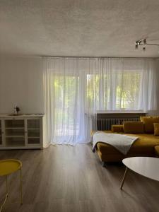 a living room with a couch and a large window at Ferienwohnung Sunny in Bad Dürrheim