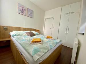 a bedroom with a bed with towels on it at Útulný apartmán u Mumlavských vodopádů in Harrachov