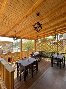 a wooden deck with tables and benches on it at V.MOD Hotel in Yerevan