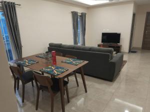 a living room with a table and a couch at Swayamkrushi 3rd Floor in Hyderabad