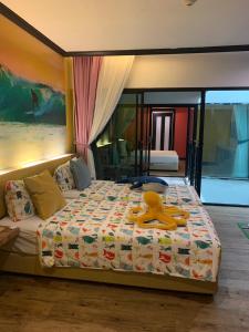 a bedroom with a bed with a yellow ribbon on it at Must Sea Hotel - SHA Hotel in Kata Beach