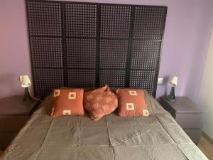 Una cama con dos almohadas encima. en Atico, Piscina, Aire Acondicionado, WI-FI, Parking Gratis, Gran Terraza en Arroyo de la Encomienda