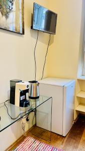 a room with a glass table and a tv on a wall at Lily CA in Cagliari