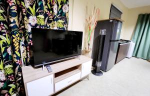 a flat screen tv sitting on top of a dresser at Unit 1O1 Nottingham Villas in Puerto Princesa City