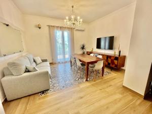 a living room with a table and a couch at Verdura Home in Caltabellotta