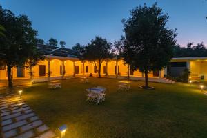 een binnenplaats met tafels en stoelen en 's nachts verlichting bij Prakriti The Nature Resort Pushkar in Pushkar