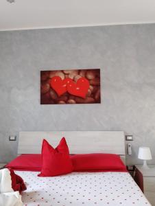 a bedroom with a bed with two hearts on the wall at Gaeta, B&B la Loggia in Gaeta